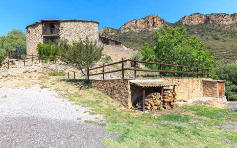 Pool area and cottage directly above